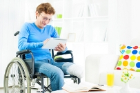 Woman in wheelchair using ipad